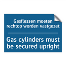 Gasflessen moeten rechtop worden /.../ - Gas cylinders must be secured /.../