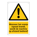 Wanneer het oranje signaal brandt, wordt de machine op afstand bediend!